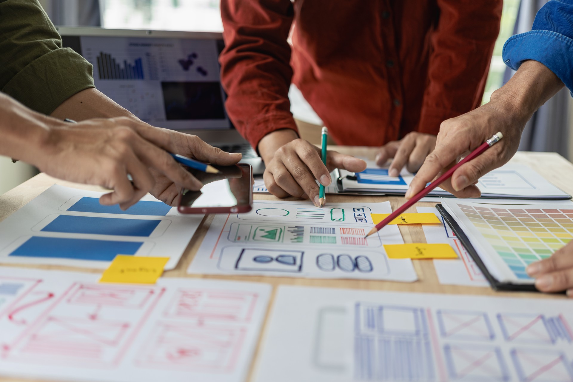 A team of UX designers works on a new website layout. Plan mobile web application development in prototyping. product development and adding new ideas